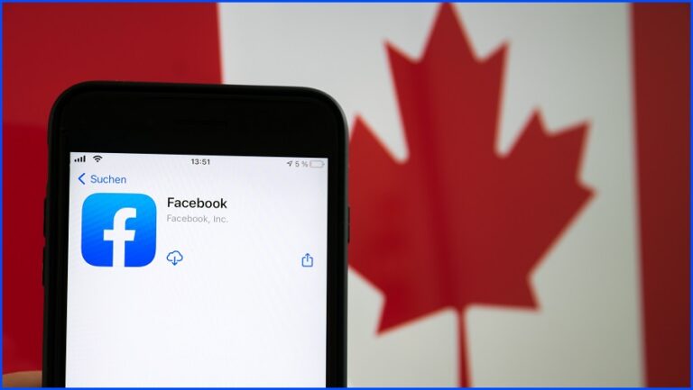 The Facebook logo on a phone in front of the Canadian flag.