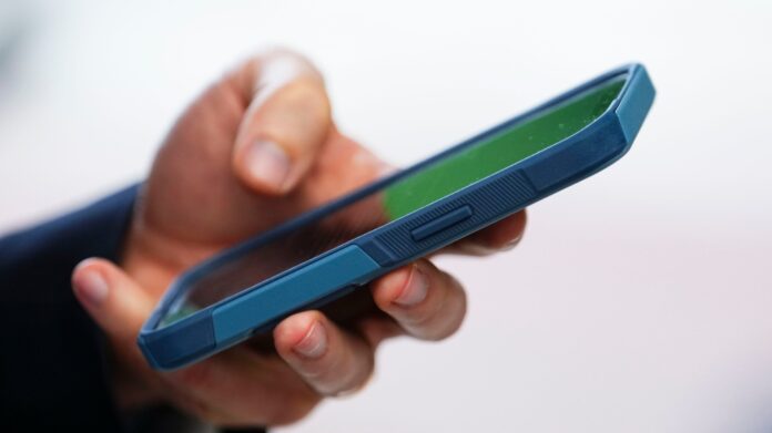 A person uses a cellphone in Ottawa on Monday, July 18, 2022. THE CANADIAN PRESS/Sean Kilpatrick