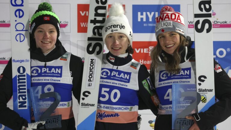 From left, Eirin Maria Kvandal from Norway, Nica Prevc from Slovenia and Abigail Strate from Canada stand at the award ceremony after the women's large hill event at the Nordic skiing/ski jumping: World Cup in Garmisch-Partenkirchen, Germany, Saturday, Dec. 30, 2023. (Karl-Josef Hildenbrand/dpa via AP)