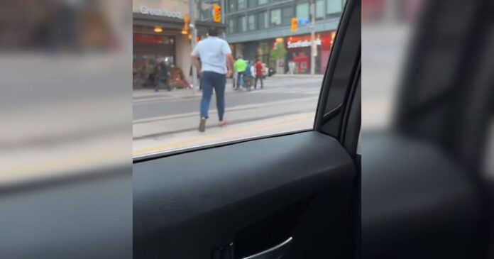 Toronto Uber driver dashes from car to chase cyclist as confused passengers record