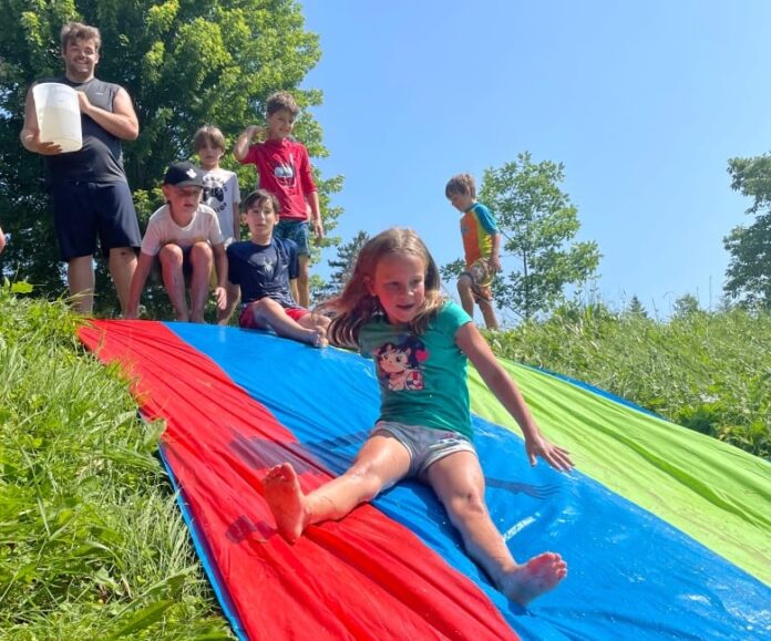 A little girl slides down a slide