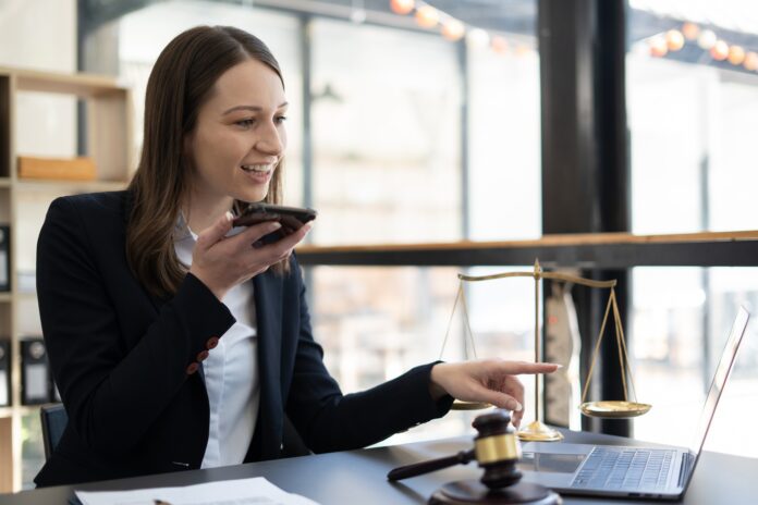 Woman lawyer working on a laptop. Legal law, advice and justice concept.