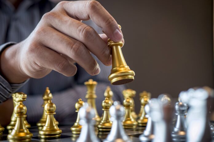 Intelligent business player plays chess game competition for planning the business strategy for development
