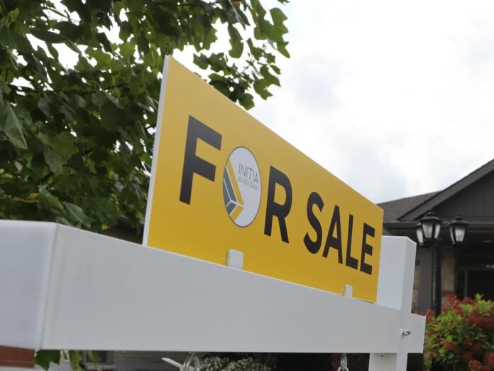 A for sale sign is seen outside a home in Sarnia, Ontario.