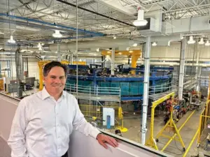 Scott Gardner, president of Svante Development, stands in front of the company's commercial carbon capture machine at Svante's headquarters in Burnaby, BC, Canada