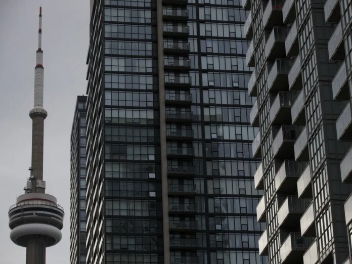 The CN Tower is seen past condominiums in Toronto, Ontario.