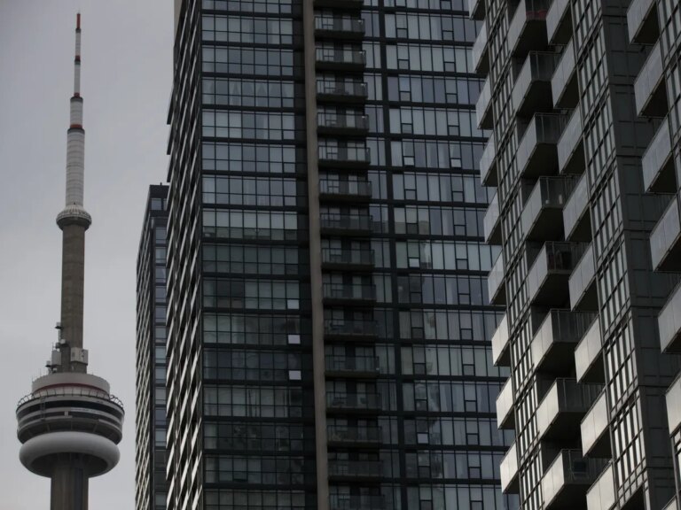 The CN Tower is seen past condominiums in Toronto, Ontario.