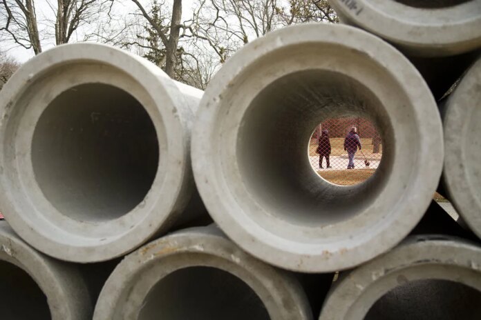 Sewer pipes are stacked under streets in London, Ontario before installation. Water and sewer systems are increasingly limiting housing construction in parts of Canada.